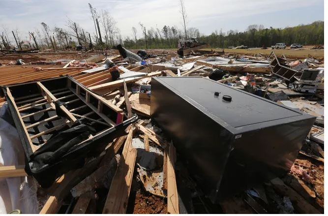 A gun vault and broken debris is all that is left of the home of Chad Mills along Hwy 15 on Saturday, April 1, 2023, in Pontotoc, Miss. Storms that dropped possibly dozens of tornadoes killed multiple people in small towns and big cities across the South and Midwest. Photo by Thomas Wells, AP