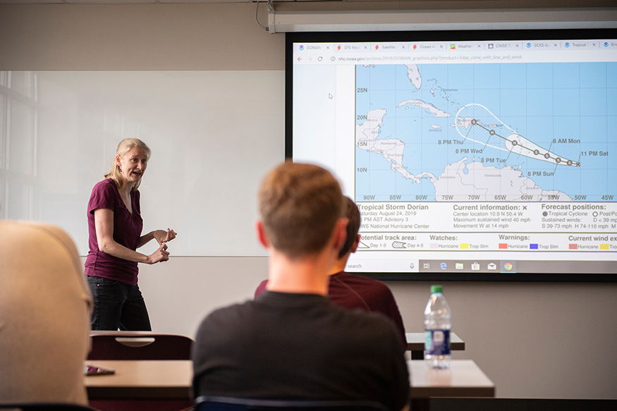 Kim Woods gives tropical storm briefing to students in meteorology class