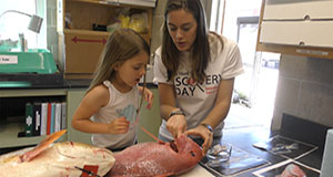 Scientist showing a girl a creature